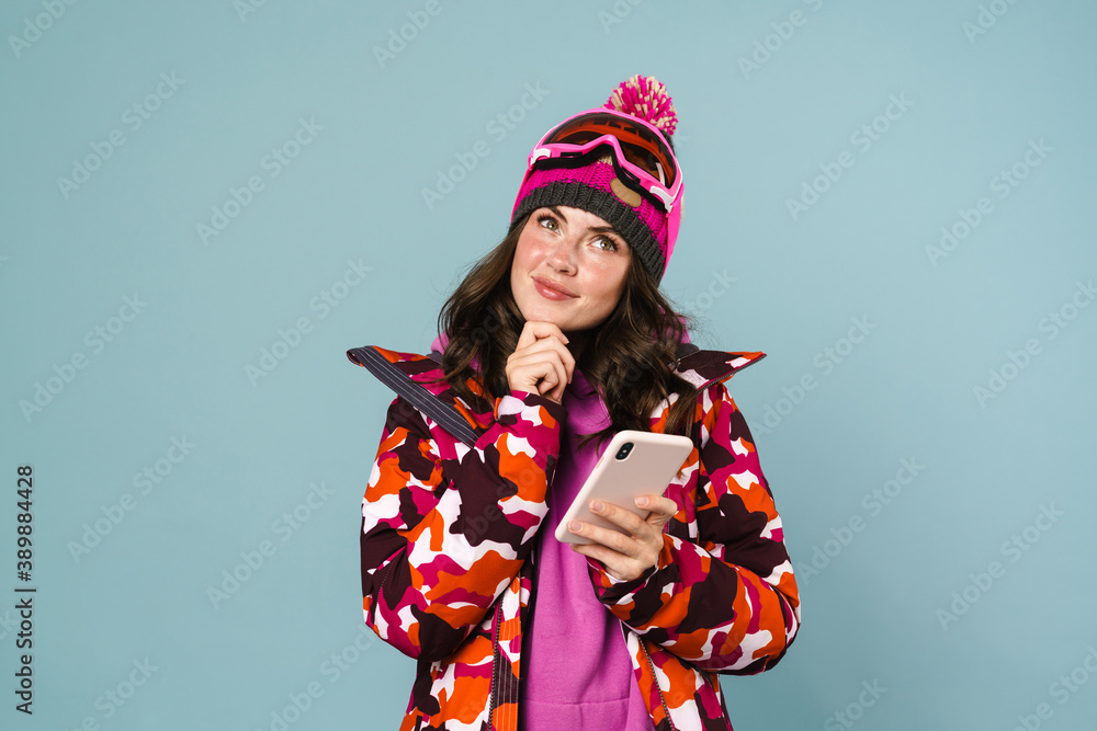 Excited beautiful sportswoman using cellphone isolated Excited beautiful sportswoman using cellphone isolated