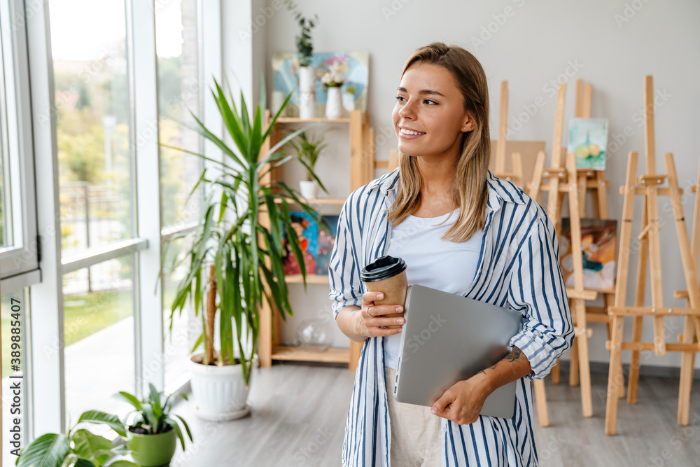 Smiling mature business woman holding laptop Smiling mature business woman holding laptop