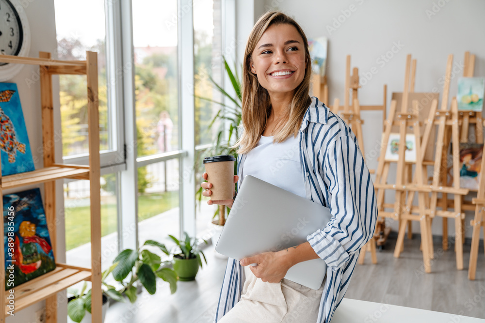 Smiling mature business woman holding laptop Smiling mature business woman holding laptop