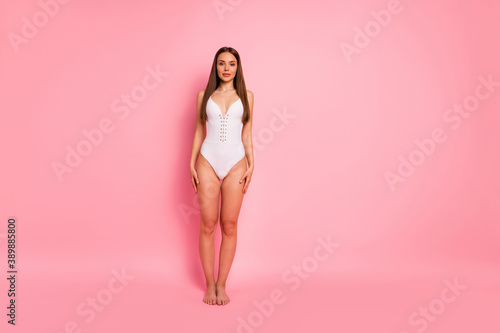 Full length body size view of her she nice-looking attractive lovely lovable winsome stunning content sportive straight-haired lady standing still isolated over pink background