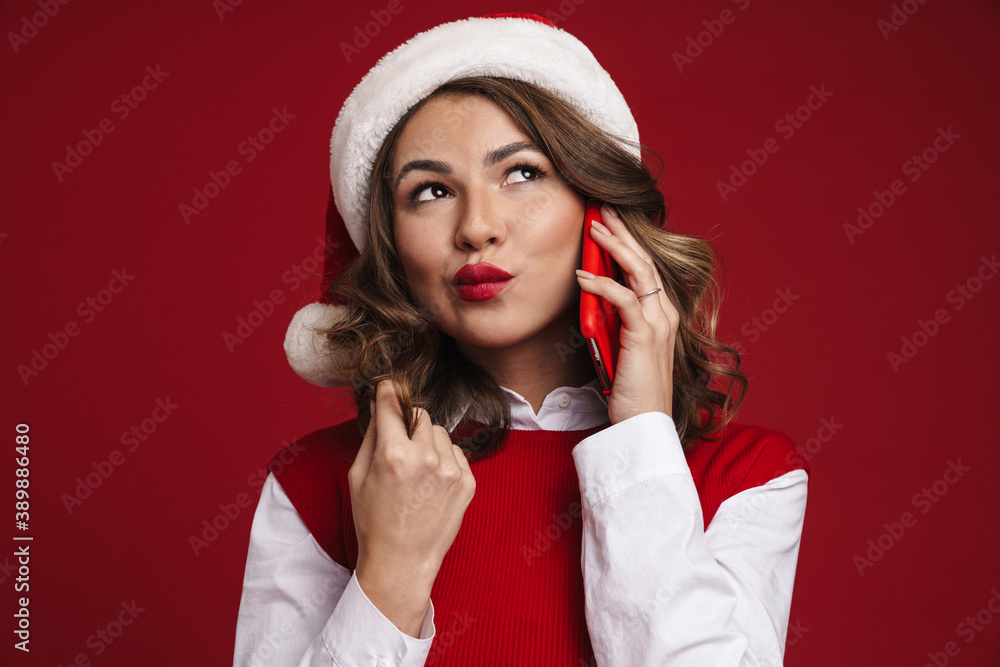 Thinking young woman in christmas santa hat Thinking young woman in christmas santa hat