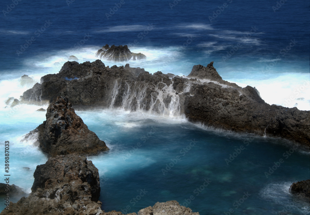 Detail of rocks with waterfalls of ocean water. Detail of rocks with waterfalls of ocean water.