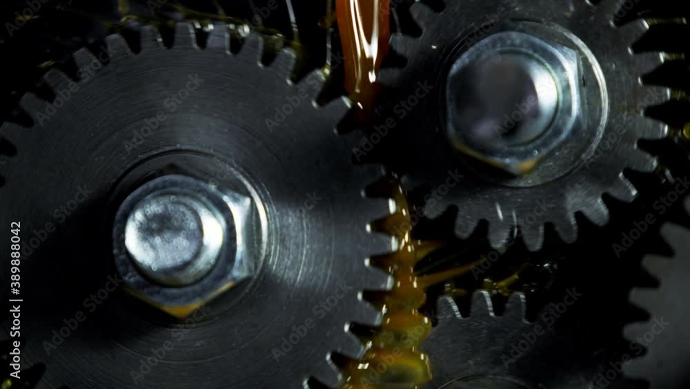 Super slow motion of rotating engine steel wheels with oil splashes ...