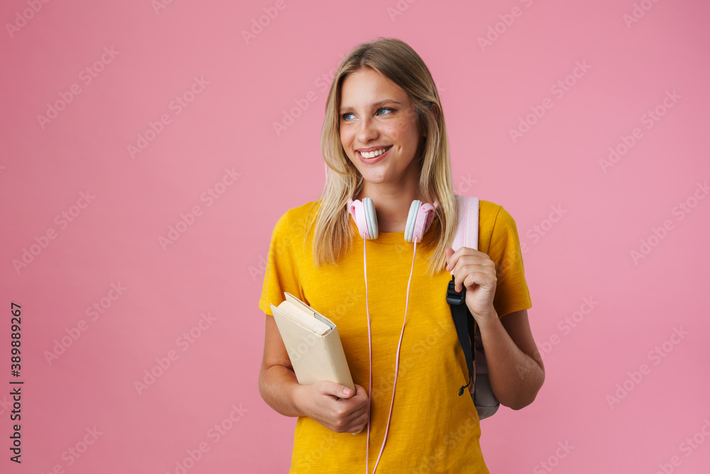 Cheerful beautiful girl posing with backpack and book Cheerful beautiful girl posing with backpack and book