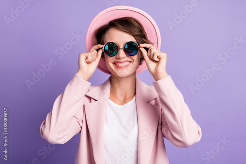 Photo of beaming young woman wear vintage outfit hands glasses isolated purple color background