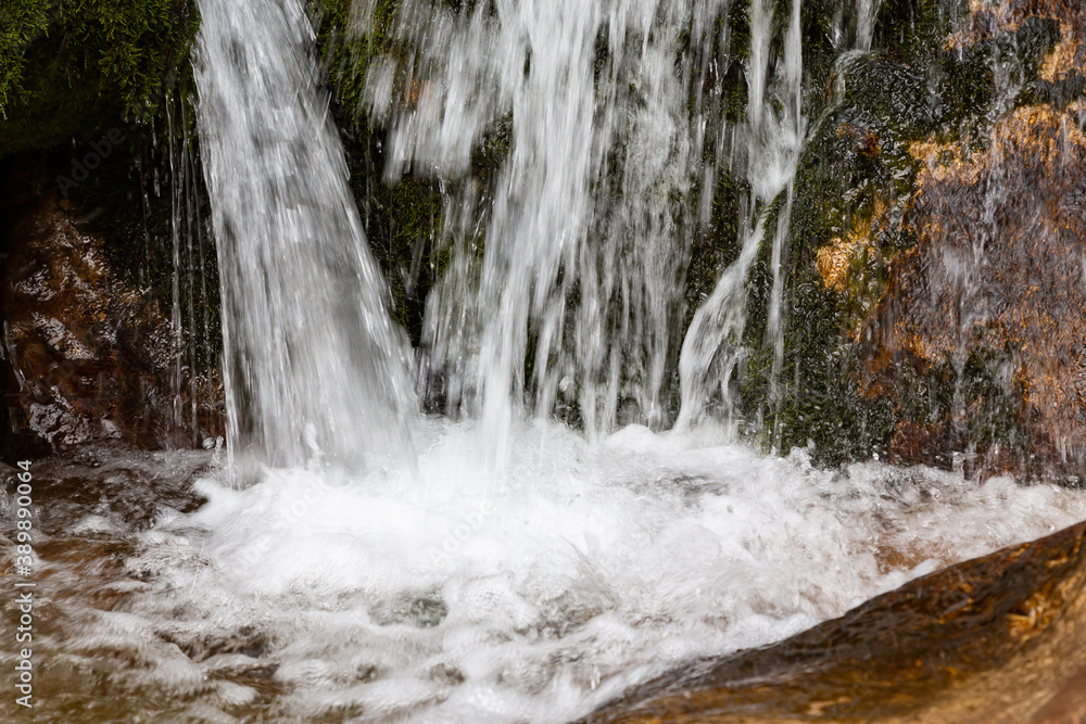 Close-up view of waterfall splashing into pool Close-up view of waterfall splashing into pool