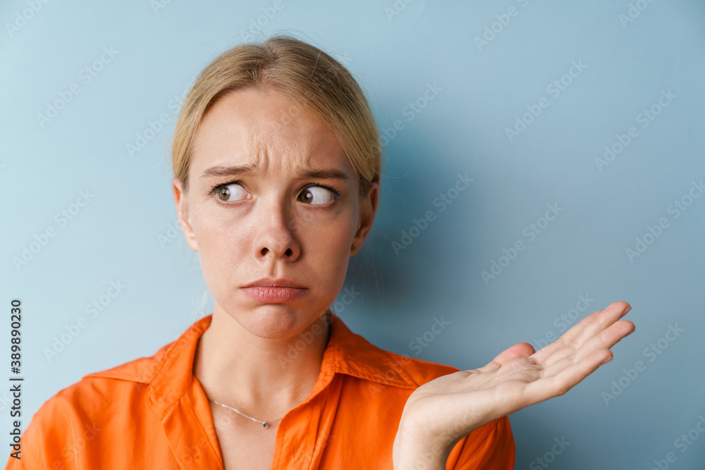 Scared beautiful girl looking aside and holding copyspace Scared beautiful girl looking aside and holding copyspace