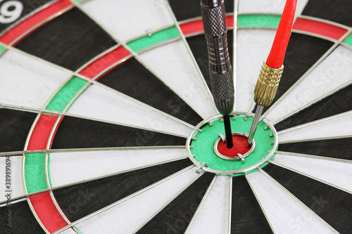 Closeup Dart arrow hitting on center dartboard Target,business, achieve and success concept, on the game focuses on success..