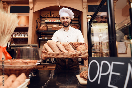 Young Bearded Man in Apron Standing in Bakery.