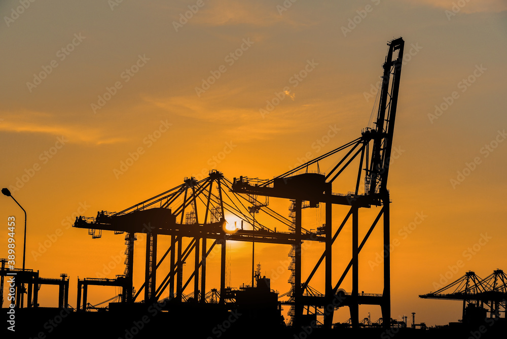 Silhlouette crane bridge in port, Container loading by crane in silhouette, Trade Port, shipping, with sunset. Silhlouette crane bridge in port, Container loading by crane in silhouette, Trade Port, shipping, with sunset.