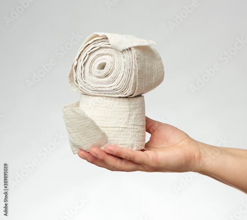 woman holds in hand a white elastic bandage for the body photo