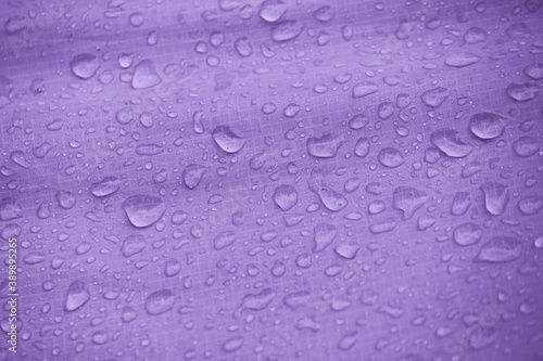 Water-repellent fabric in large raindrops. Rip-stop fabric. Tent textiles. Waterproof material.