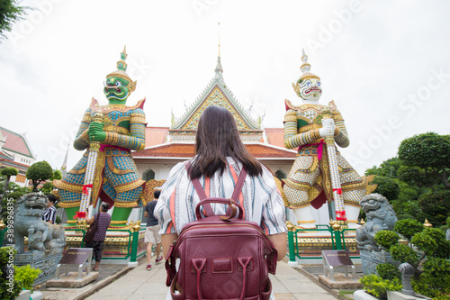 Photography Asian girl tourist smiling while visiting Wat Arun or Temple of Dawn backpacker
