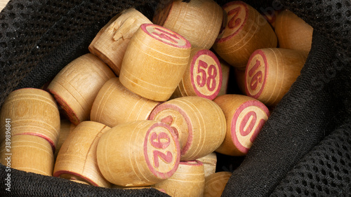 Playing cards for Lotto game with black bag on a wooden light table