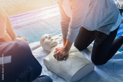 CPR training medical procedure – Demonstrating chest compressions on CPR in the class.
