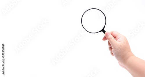 Hand holding magnifying glass isolated on white background.