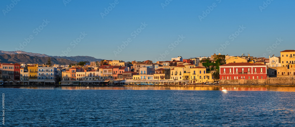Beautiful view of Old Venetian port of Chania, Crete, Greece, shop, hotels, cafes and restaurants on quay.Maritime museum of Crete. Cretan mountains