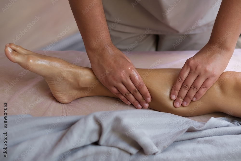 Caucasian woman receiving a leg massage on spa therapy. Healthcare concept. Caucasian woman receiving a leg massage on spa therapy. Healthcare concept.