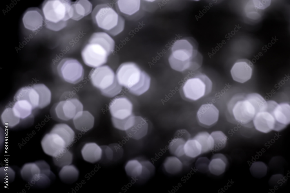 Blurred lights dark gray background. Abstract bokeh with soft light. Shiny festive christmas texture