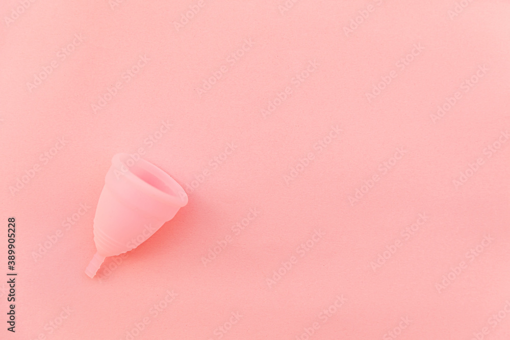 Simply minimal design menstrual cup Isolated on pink pastel background. Woman modern alternative eco gynecological hygiene in menstruation period. Container for blood. Flat lay top view, copy space Simply minimal design menstrual cup Isolated on pink pastel background. Woman modern alternative eco gynecological hygiene in menstruation period. Container for blood. Flat lay top view, copy space
