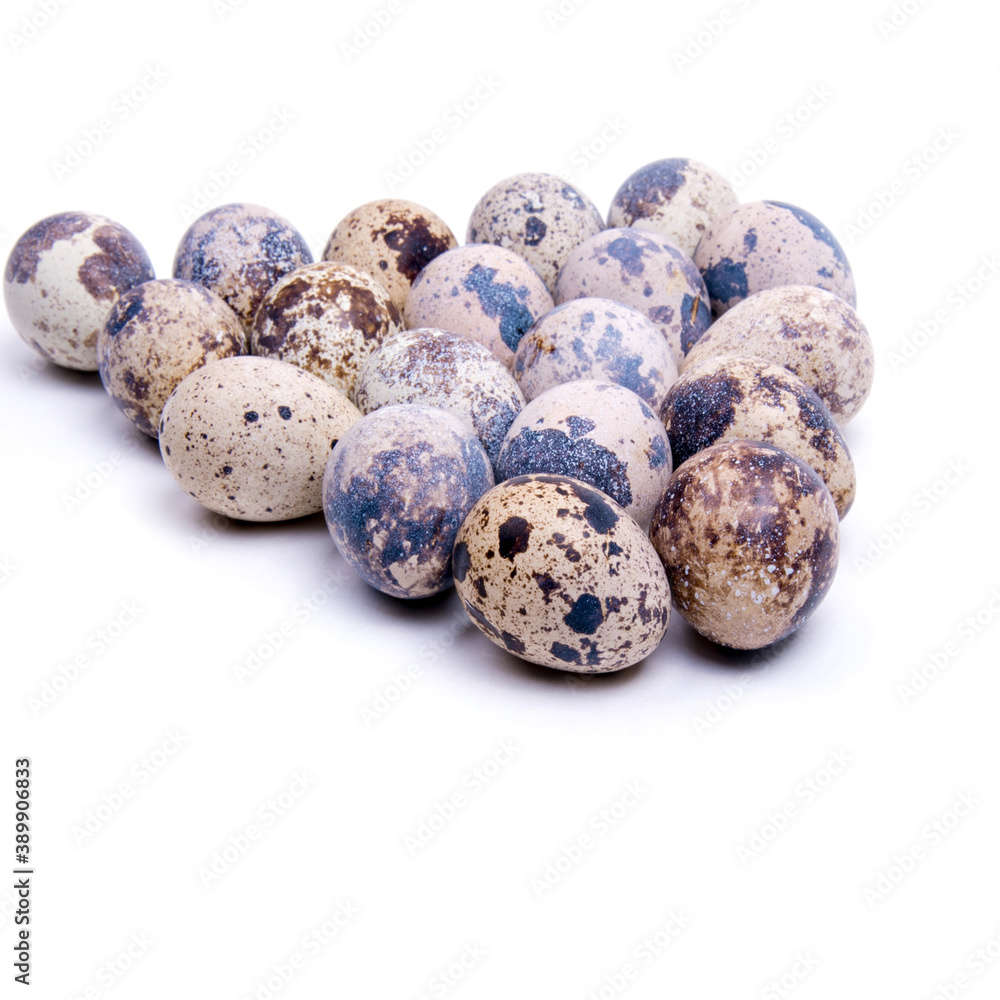 Quail eggs laid out in a triangle shape, close-up on a white background, copy space Quail eggs laid out in a triangle shape, close-up on a white background, copy space