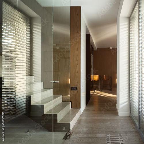 Stairs behind glass wall in home corridor © Dariusz Jarzabek