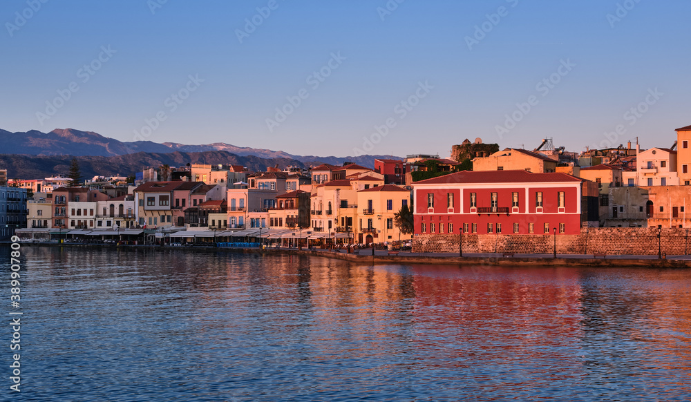 Sunrise view of Old Venetian harbour, Chania, Crete, Greece, its quay.Maritime museum of Crete in first sunrays. Cretan hills and mountains 