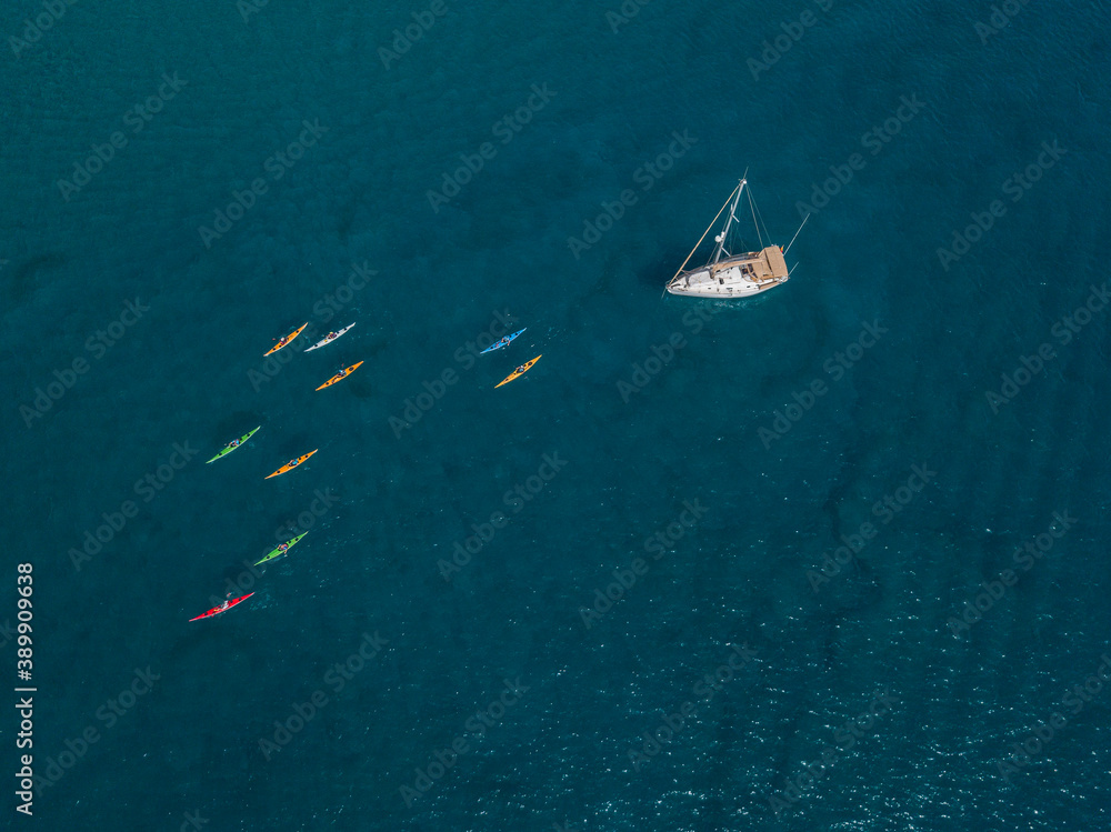 Aerial view of canoes sailing near the rugged coastlines and beaches of Lanzarote, Spain, Canaries. Explore the island. Bathers on the beach and in the Atlantic Ocean. Papagayo Aerial view of canoes sailing near the rugged coastlines and beaches of Lanzarote, Spain, Canaries. Explore the island. Bathers on the beach and in the Atlantic Ocean. Papagayo