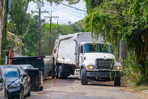 Sanitation Truck Stuck Between a Dumpster and a Parked Car in an Uptown Neighborhood © William A. Morgan
