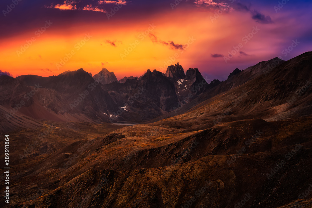 Aerial View of Scenic Landscape and Mountains on a Cloudy Fall Season in Canadian Nature. Colorful Twilight Sky Artistic Render. Taken in Tombstone Territorial Park, Yukon, Canada.