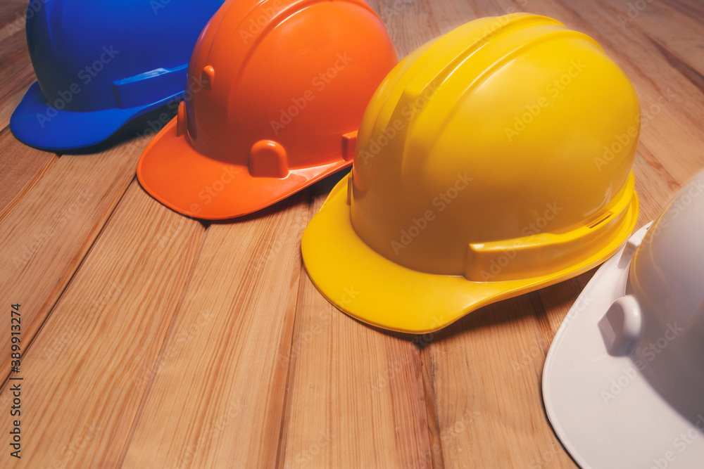 Construction helmets, hard safety helmet hat for engineer on wooden table Construction helmets, hard safety helmet hat for engineer on wooden table