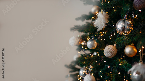 green christmas tree with silver ornaments and greay background photo