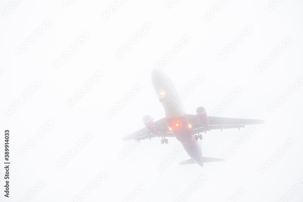 view of landing plane in misty weather view of landing plane in misty weather