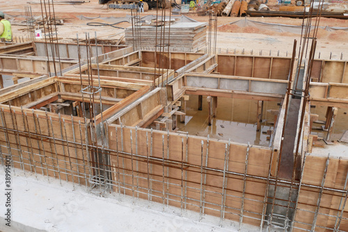 KUALA LUMPUR, MALAYSIA -MARCH 5, 2020: Building ground beam under construction using temporary timber plywood formwork at the site. Reinforced by the reinforcement steel to strengthen the structure. 