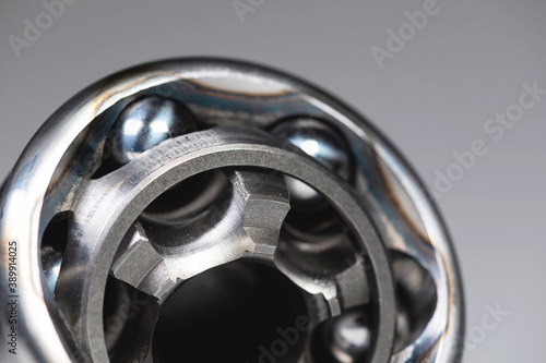 Macro close-up CV joint new with copy space on gray background. Shallow depth of field new metal detail. Background new spare parts photo