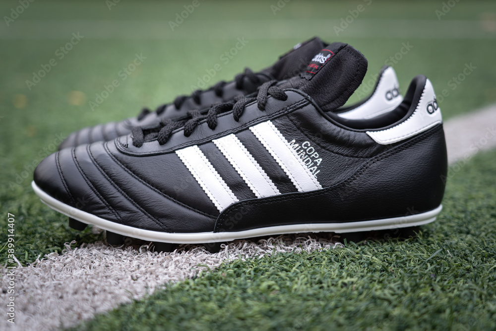 Bangkok / Thailand - May 2020 : Adidas "Copa mundial" is placed on football  turf pitch, the model is