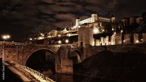 Toledo in Spain at night. Famous UNESCO World Heritage Site. Panorama of the historic city with Alcazar fortress at night-time.