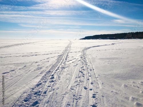 White winter road in a snow field