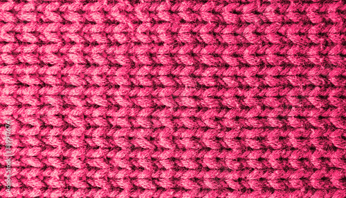 Knitted pink background. Yarn texture. Horizontal knitting