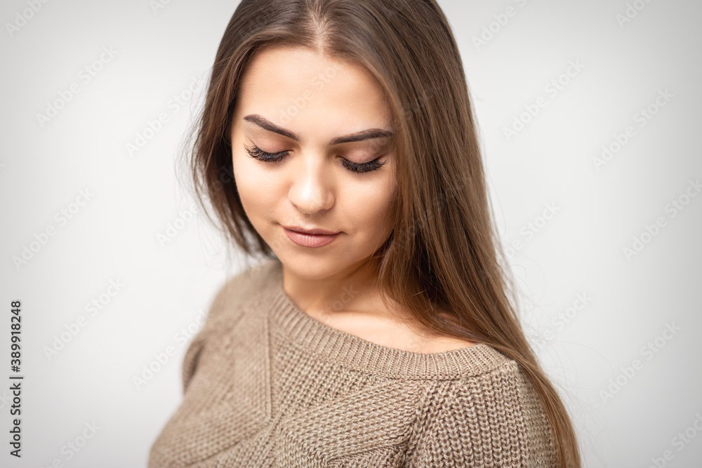 Portrait of beautiful young caucasian woman with closed eyes after eyelash extension procedure and permanent makeup Portrait of beautiful young caucasian woman with closed eyes after eyelash extension procedure and permanent makeup