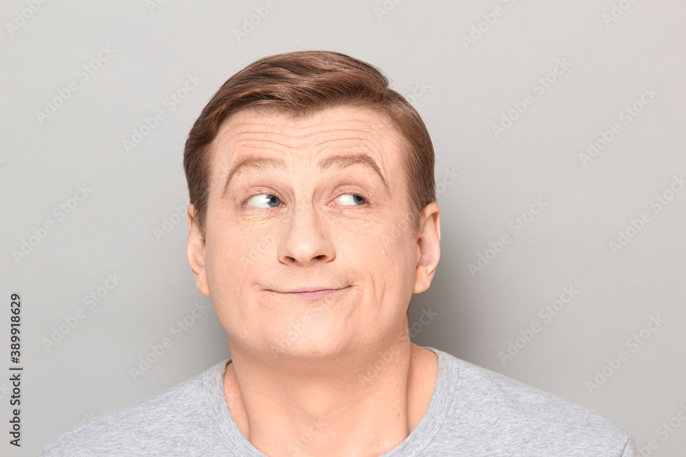 Portrait of funny dreamy man imagining something in mind and smiling Portrait of funny dreamy man imagining something in mind and smiling