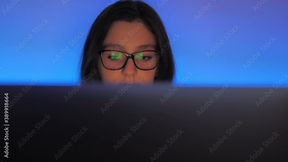 Teenage Girl Reading Social Networks Comments and Messages on a Laptop Computer. Cyberbullying Concept, Close Up Teenage Girl Reading Social Networks Comments and Messages on a Laptop Computer. Cyberbullying Concept, Close Up