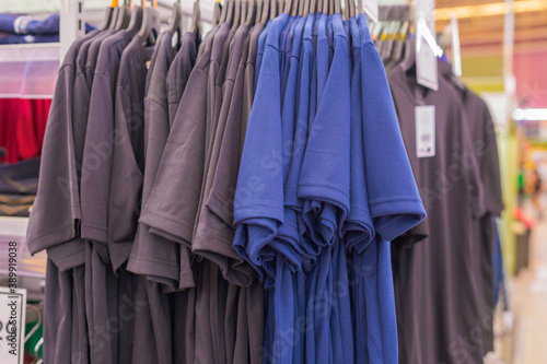 Closeup photo of Men's shirts hanging. Different colored men's shirts. Select Focus