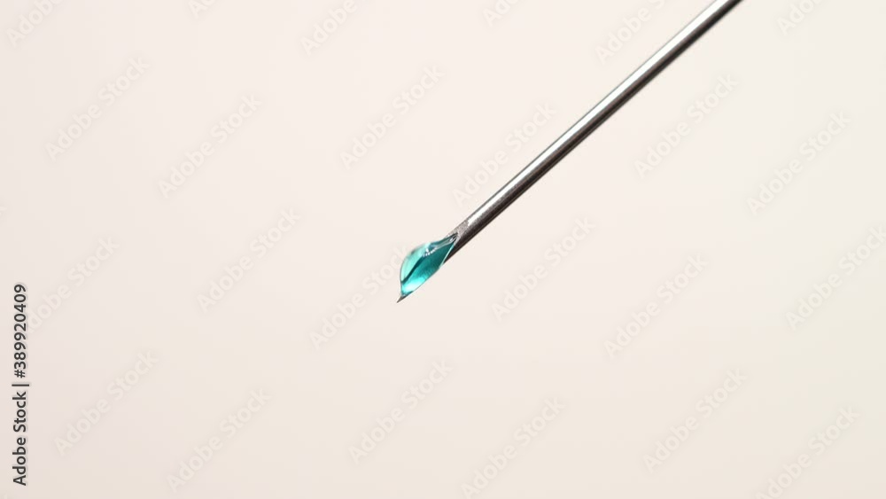Medical vaccine dripping from the syringe needle. Concept of lab developing research of vaccine against Coronavirus, COVID-19. Pre-clinical evaluation and clinical phase trials development test Medical vaccine dripping from the syringe needle. Concept of lab developing research of vaccine against Coronavirus, COVID-19. Pre-clinical evaluation and clinical phase trials development test