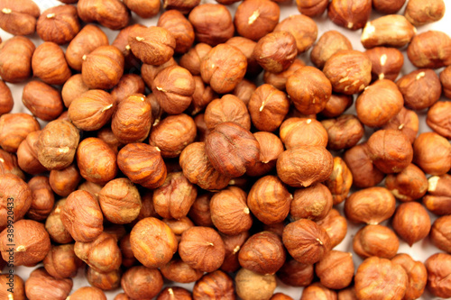 Brown dried peeled hazelnuts. Nut background