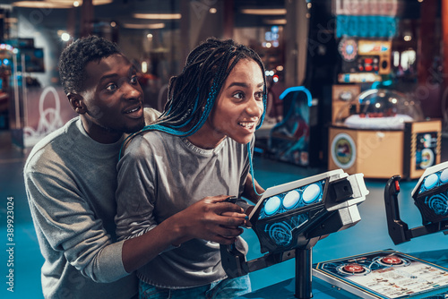 Black woman having fun with man in center. 