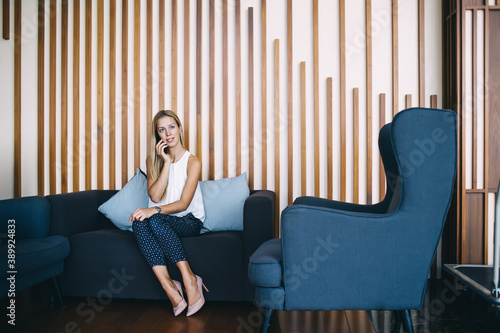 Photography Content woman talking on smartphone in waiting area
