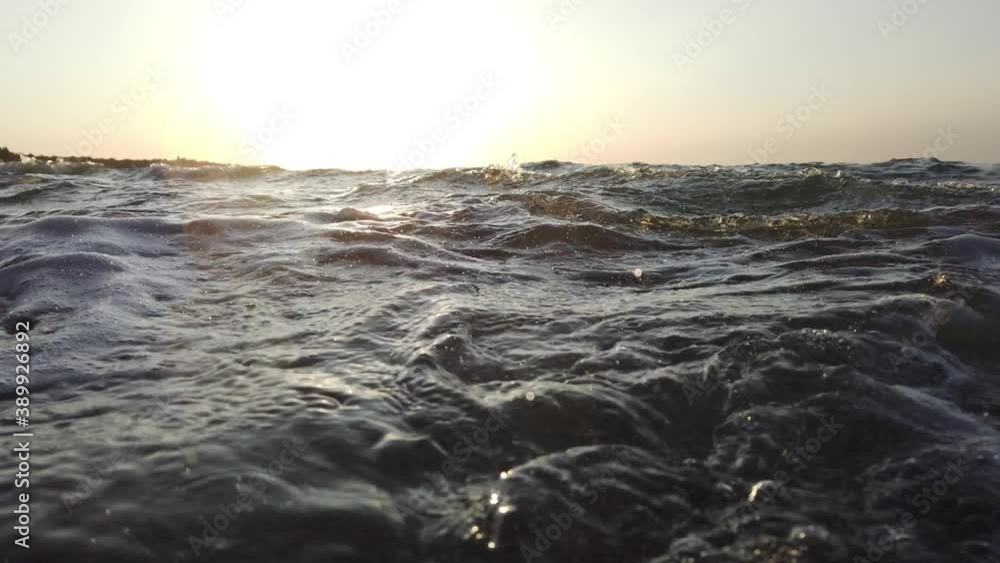 Beach waves splashing on rocks being shot up close at slow motion Beach waves splashing on rocks being shot up close at slow motion