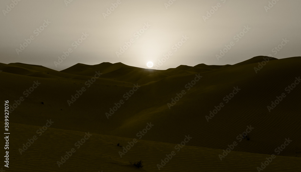 sepia landscape sunset in the desert as you can the sun setting on the horizon right over the dunes sepia landscape sunset in the desert as you can the sun setting on the horizon right over the dunes
