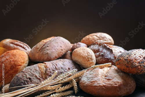 heap of various bread on dark brown background